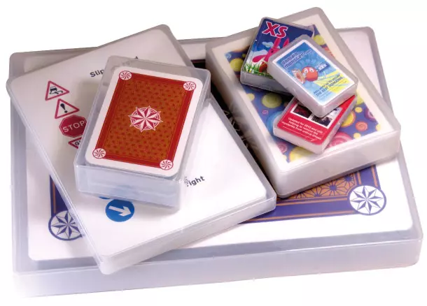 A collection of different size plastic playing card boxes.